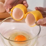 hands holding a yellow egg cracker over a bowl, showcasing the egg cracker tool for mess-free egg cracking.