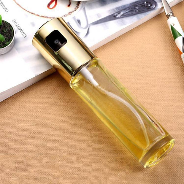 Oil vinegar spray bottle for cooking, featuring a sleek design and pump spray mechanism on a kitchen countertop.