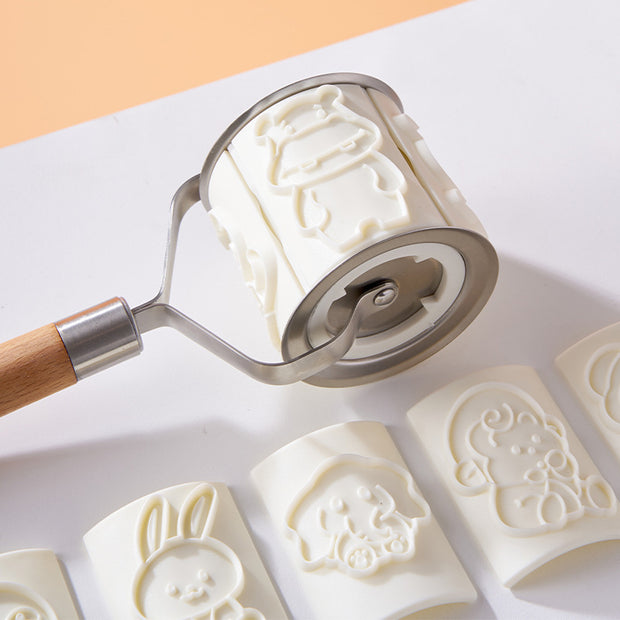 Cartoon animal biscuit mold with roller and various shaped cookie impressions in white color.
