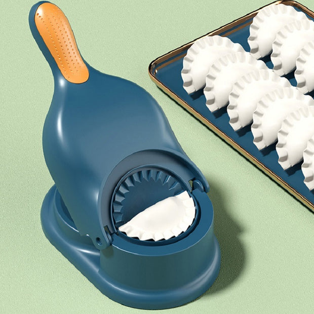 2 in 1 dumpling maker tool alongside freshly made wavy-shaped dumplings on a baking tray.